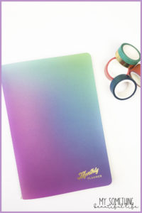 petite monthly planner with gradient patter on cover and washi tape
