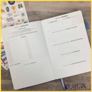 inside of the clever fox self care journal with stickers under the book